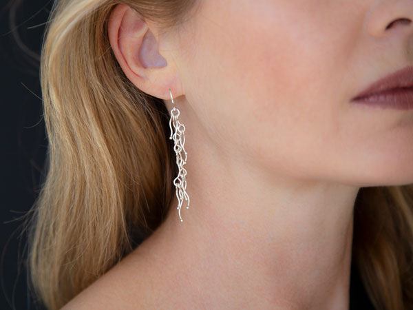 artist wearing liquid silver earrings